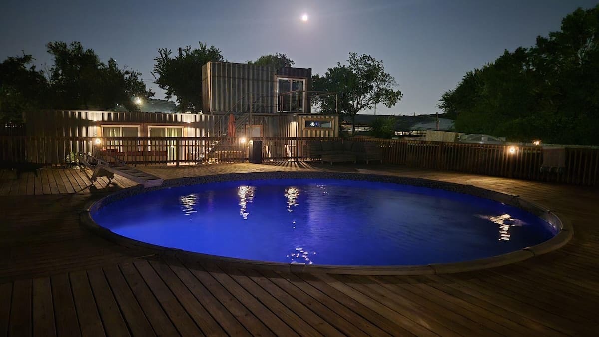 Helotes Haciendas container homes and pool at night